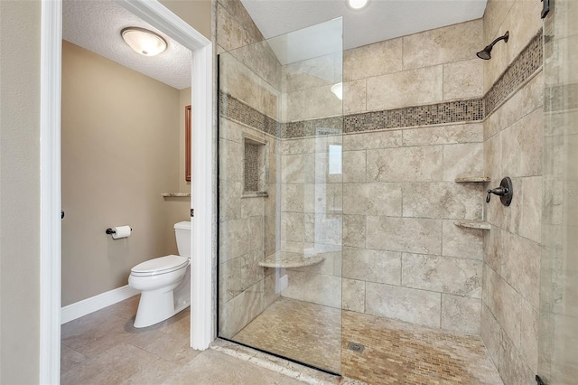 full bath featuring a walk in shower, a textured ceiling, toilet, and baseboards