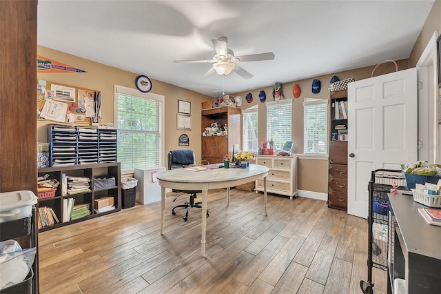 office space with ceiling fan, light wood-style flooring, and baseboards