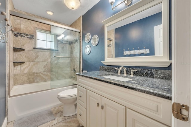 bathroom with toilet, vanity, and enclosed tub / shower combo