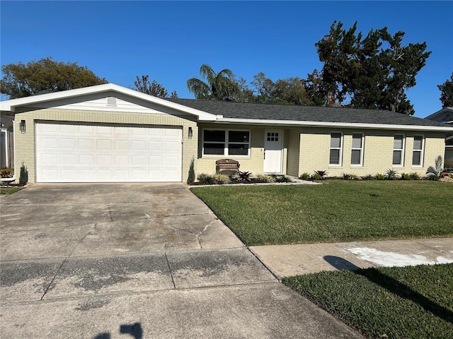 ranch-style house with concrete driveway, roof with shingles, an attached garage, a front lawn, and brick siding