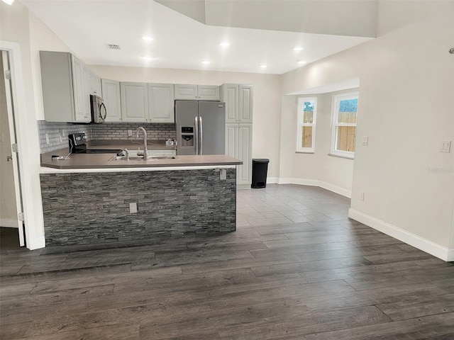 1118 Meditation Loop, Port Orange, FL 32129 - kitchen featuring stainless steel appliances, gray cabinets, a peninsula, a sink, and decorative backsplash