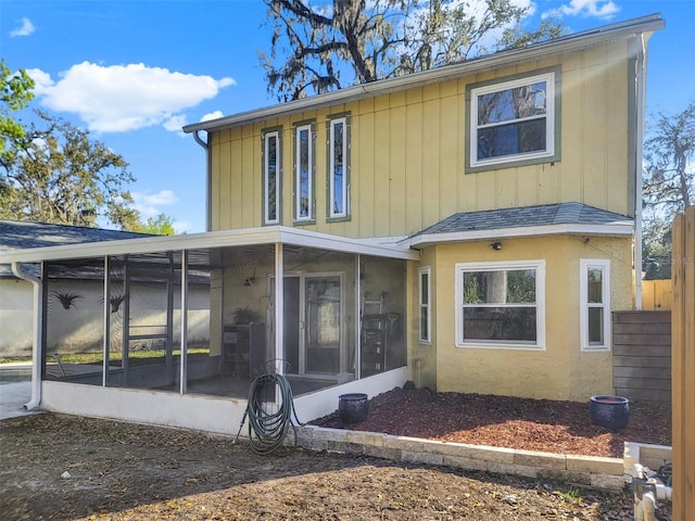 1118 Meditation Loop, Port Orange, FL 32129 - rear view of house featuring a sunroom, fence, and a shingled roof