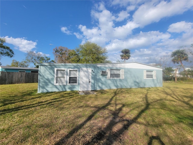 exterior space featuring fence and a front lawn