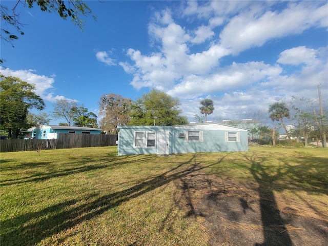 view of front of property with fence and a front lawn