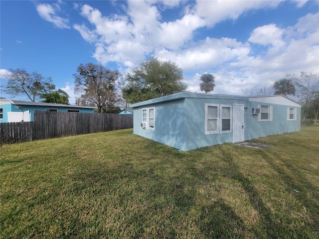 view of outbuilding featuring fence