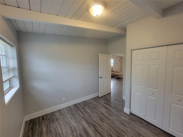 305 Elsie Ave, Daytona Beach, FL 32117 - unfurnished bedroom featuring baseboards, dark wood finished floors, wood ceiling, vaulted ceiling with beams, and a closet