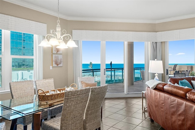 tiled dining room featuring a wealth of natural light, a notable chandelier, and crown molding