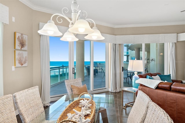 dining area featuring a water view, ornamental molding, and a chandelier