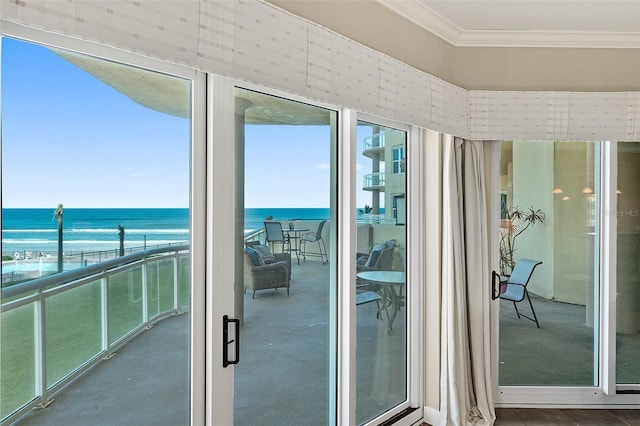 doorway to outside featuring a water view and ornamental molding