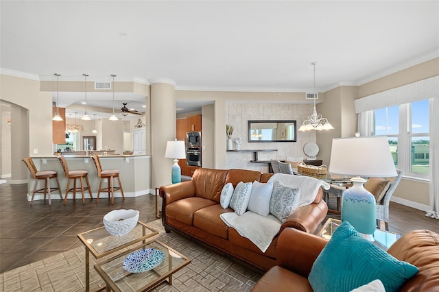 tiled living area featuring baseboards, visible vents, arched walkways, an inviting chandelier, and crown molding