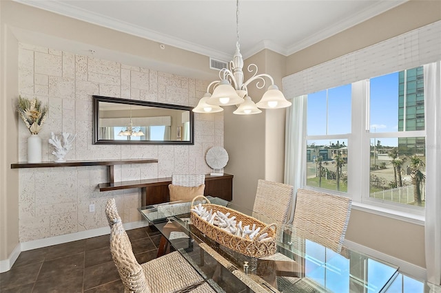 dining area featuring crown molding, dark tile patterned floors, baseboards, and an inviting chandelier