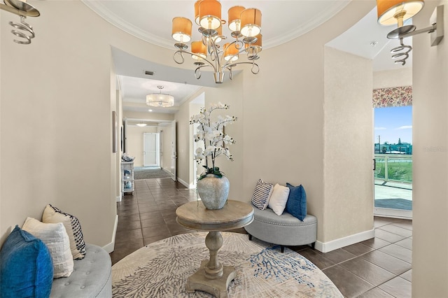 hall featuring crown molding, baseboards, a notable chandelier, and tile patterned floors