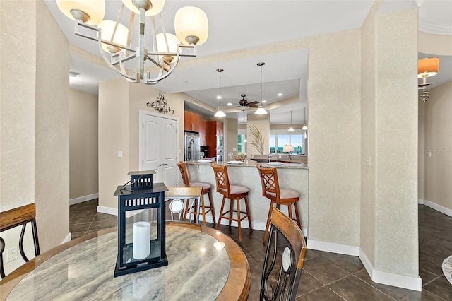 dining space featuring baseboards, dark tile patterned flooring, visible vents, and an inviting chandelier