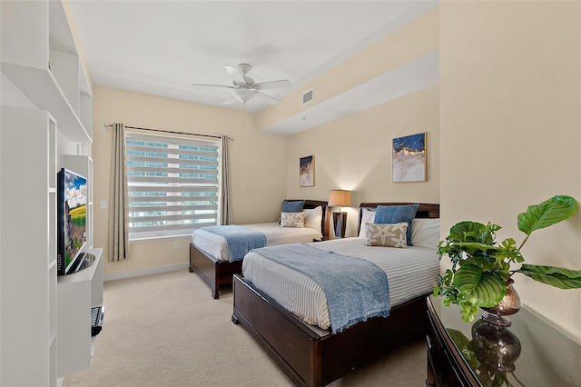 bedroom featuring baseboards, a ceiling fan, visible vents, and light colored carpet