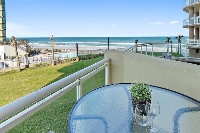 balcony with a water view and a beach view