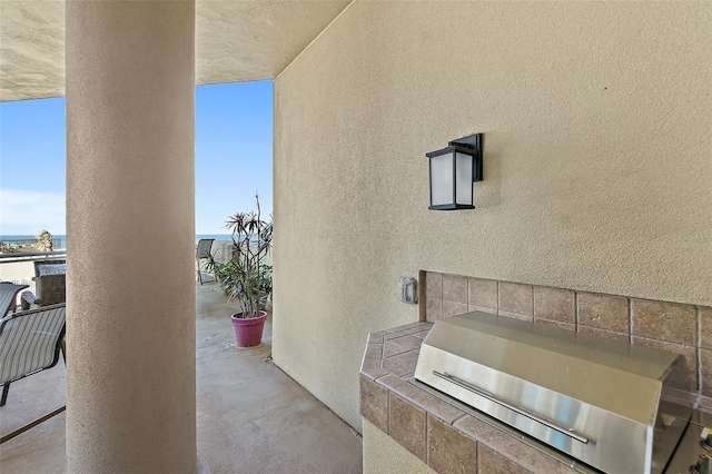 view of patio with a balcony and area for grilling