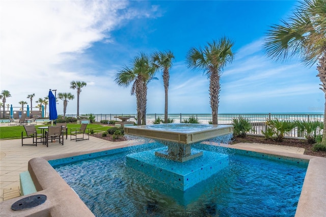 view of pool with a patio area, a water view, and fence