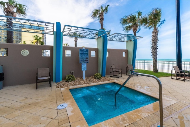 view of pool with a water view, fence, a pergola, and a patio