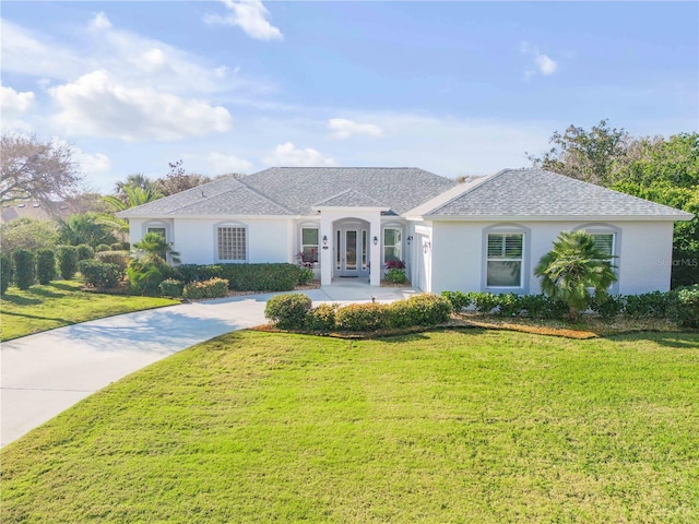 view of front of home featuring roof with shingles, french doors, a front lawn, and stucco siding