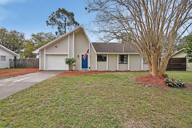 view of front of home featuring driveway, a garage, fence, a front yard, and stucco siding