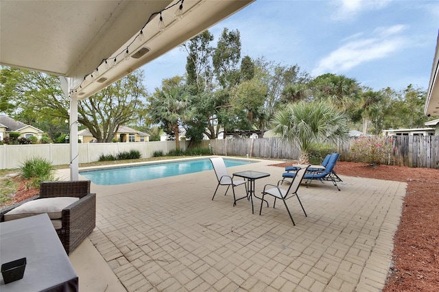 view of pool with a fenced in pool, a fenced backyard, and a patio