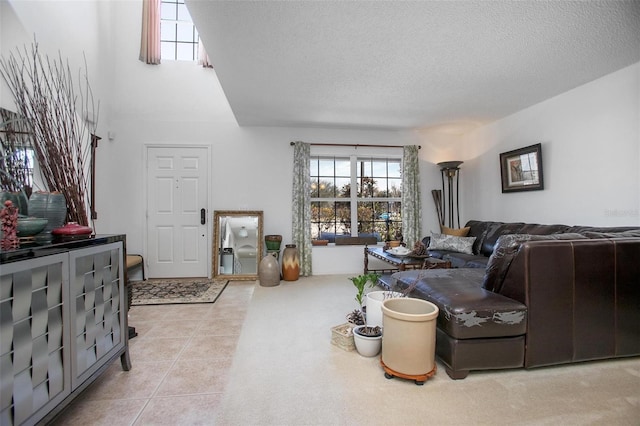 living room with a textured ceiling and tile patterned floors