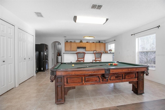 rec room with arched walkways, pool table, visible vents, and light tile patterned flooring