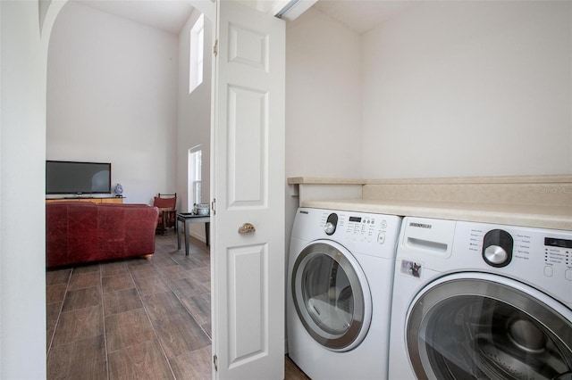 laundry area with washer and dryer, laundry area, and dark wood-style flooring