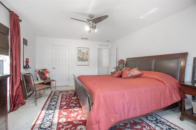 bedroom with light carpet, ceiling fan, and visible vents