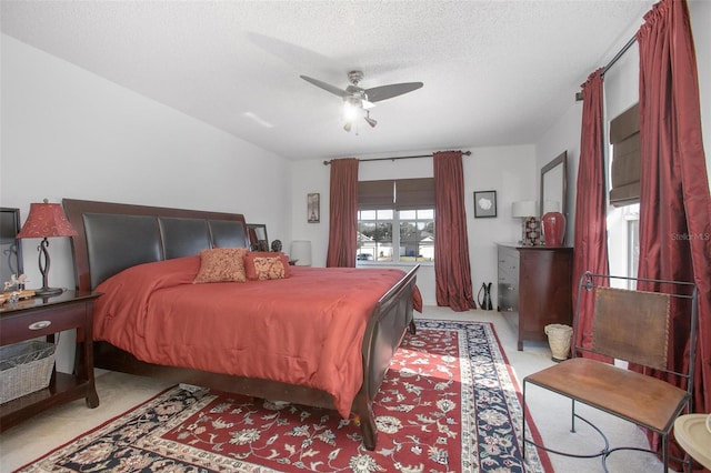 bedroom with carpet floors, a ceiling fan, and a textured ceiling