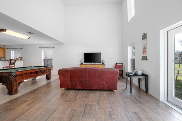 living room featuring pool table, visible vents, a towering ceiling, and wood finished floors