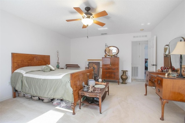 bedroom featuring visible vents and light colored carpet