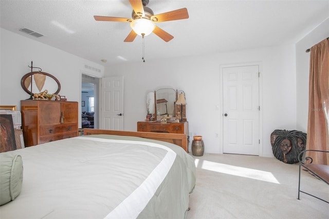 bedroom with carpet, visible vents, and ceiling fan