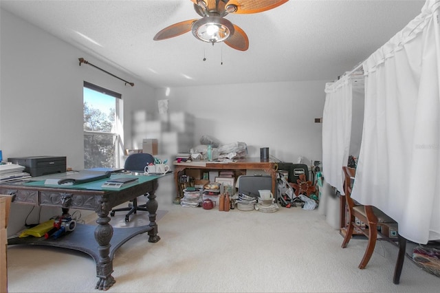 office space with a textured ceiling, ceiling fan, and carpet flooring