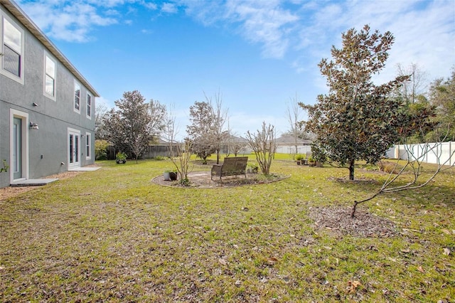 view of yard featuring fence and a patio