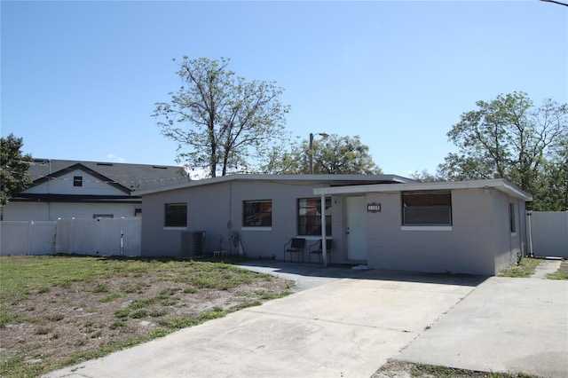 ranch-style house featuring central AC unit, driveway, a gate, and fence