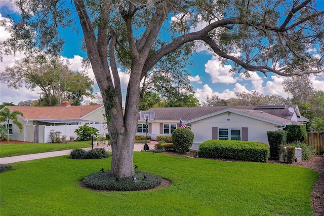 single story home with a front yard and fence