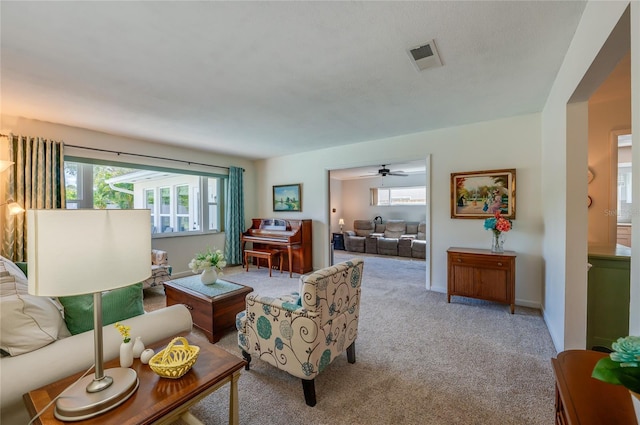 living area featuring carpet flooring, visible vents, and baseboards