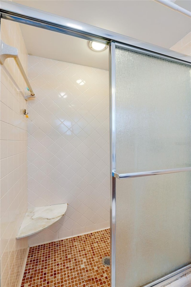 bathroom with a shower stall