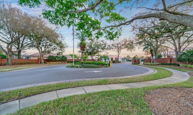 surrounding community featuring aphalt driveway and fence