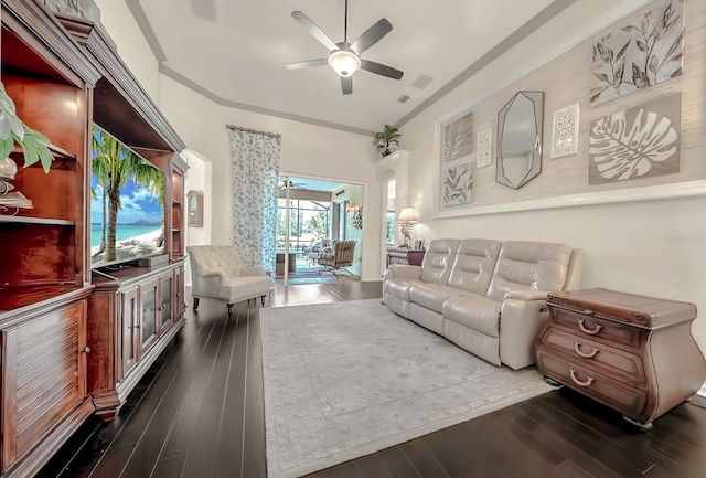 living area featuring dark wood-style flooring, crown molding, and ceiling fan