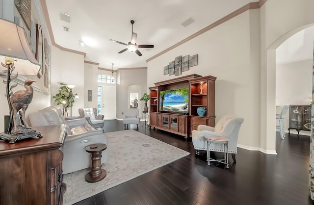 living area featuring arched walkways, dark wood-style flooring, a ceiling fan, ornamental molding, and baseboards