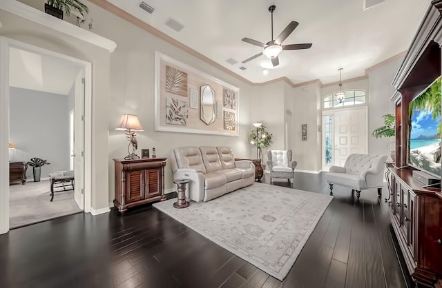 living area with a ceiling fan, baseboards, visible vents, dark wood-style floors, and crown molding