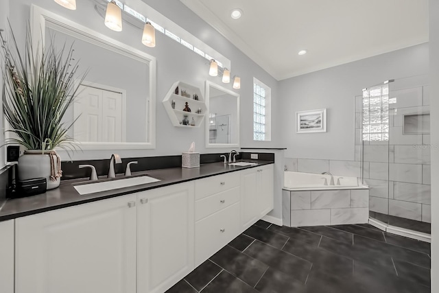 full bath with double vanity, a sink, a bath, and tile patterned floors