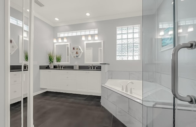 bathroom featuring crown molding, double vanity, visible vents, a sink, and a bath