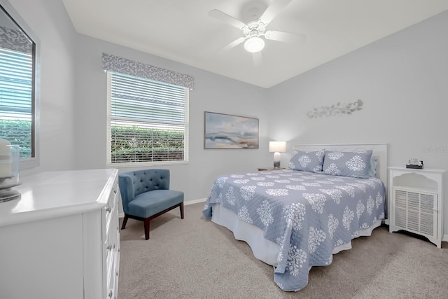 bedroom featuring baseboards, a ceiling fan, and light colored carpet