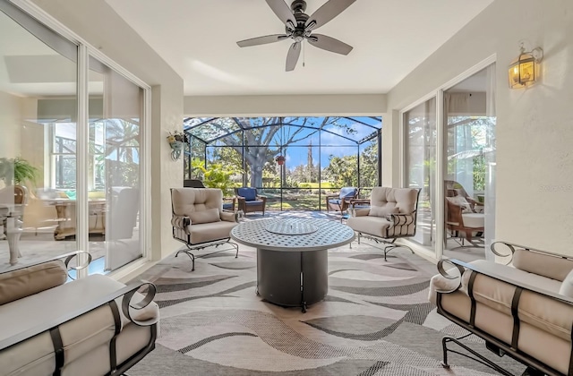 sunroom / solarium featuring ceiling fan