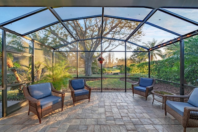 view of patio featuring glass enclosure and an outdoor hangout area