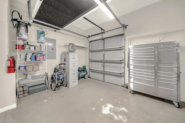 garage with electric panel and baseboards