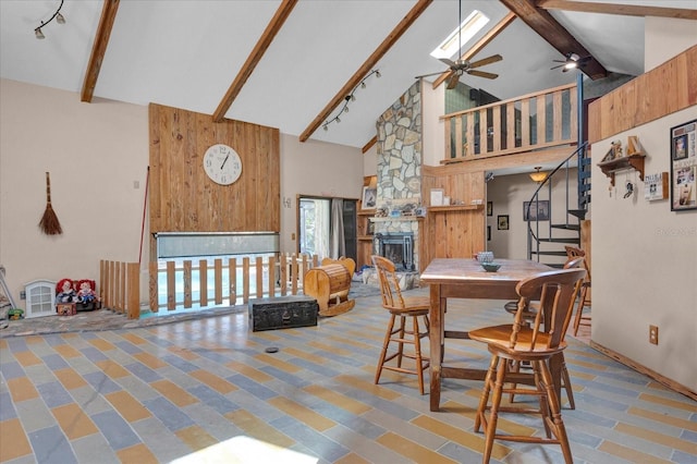 dining area with stairway, a fireplace, high vaulted ceiling, and beamed ceiling